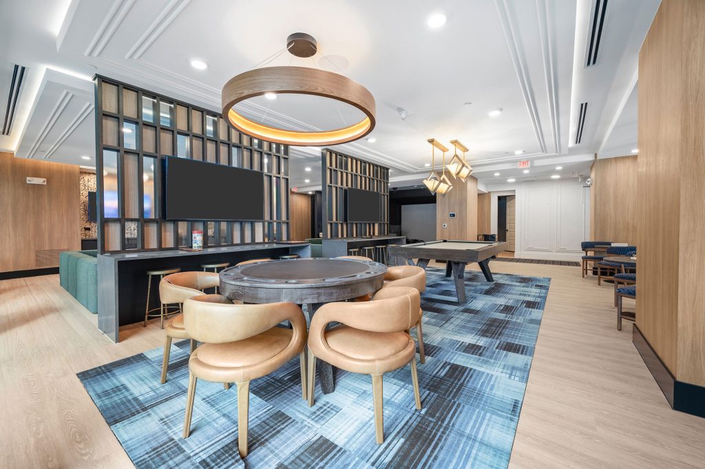 The Watt apartments lounge room with a poker table and pool table.